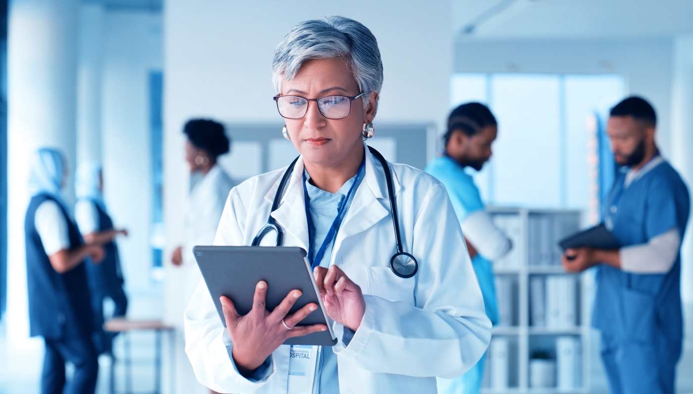 Doctor using Tablet to input patient data