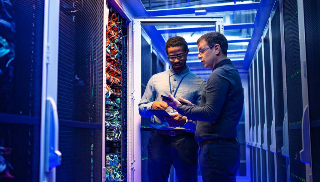 Two men working in a data center